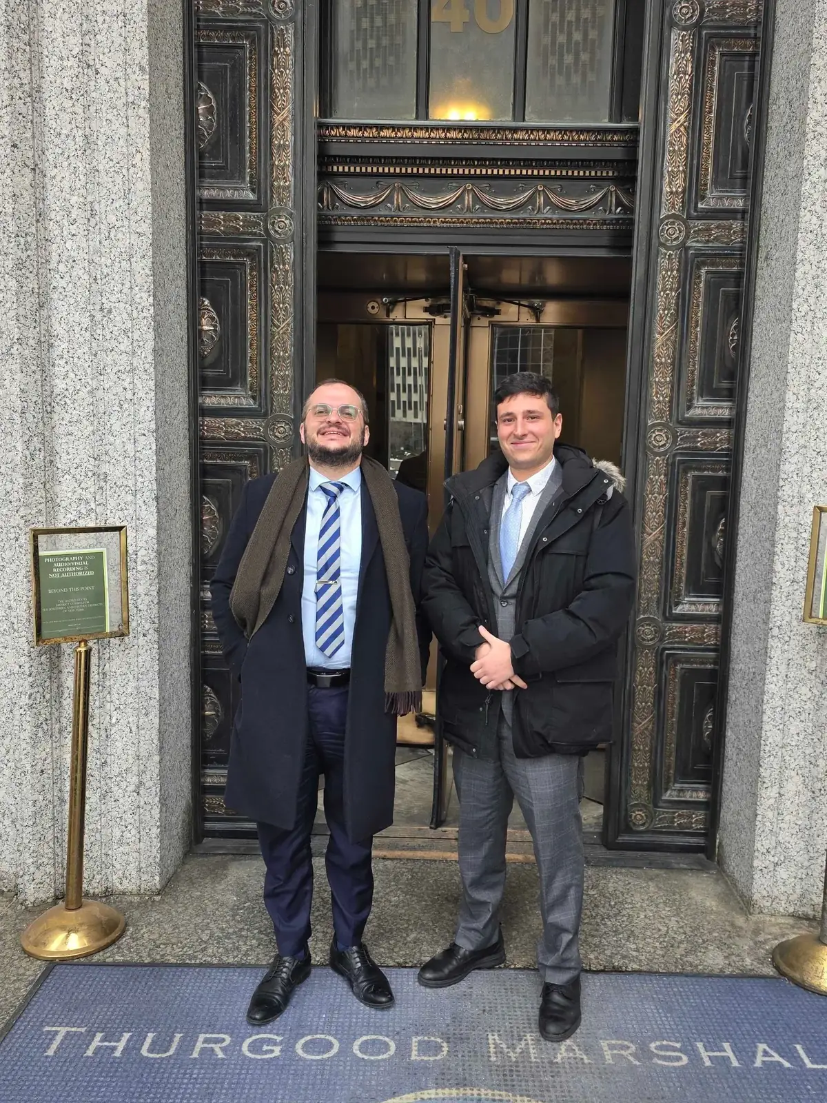 Usher Law Group attorneys at a federal courthouse entrance